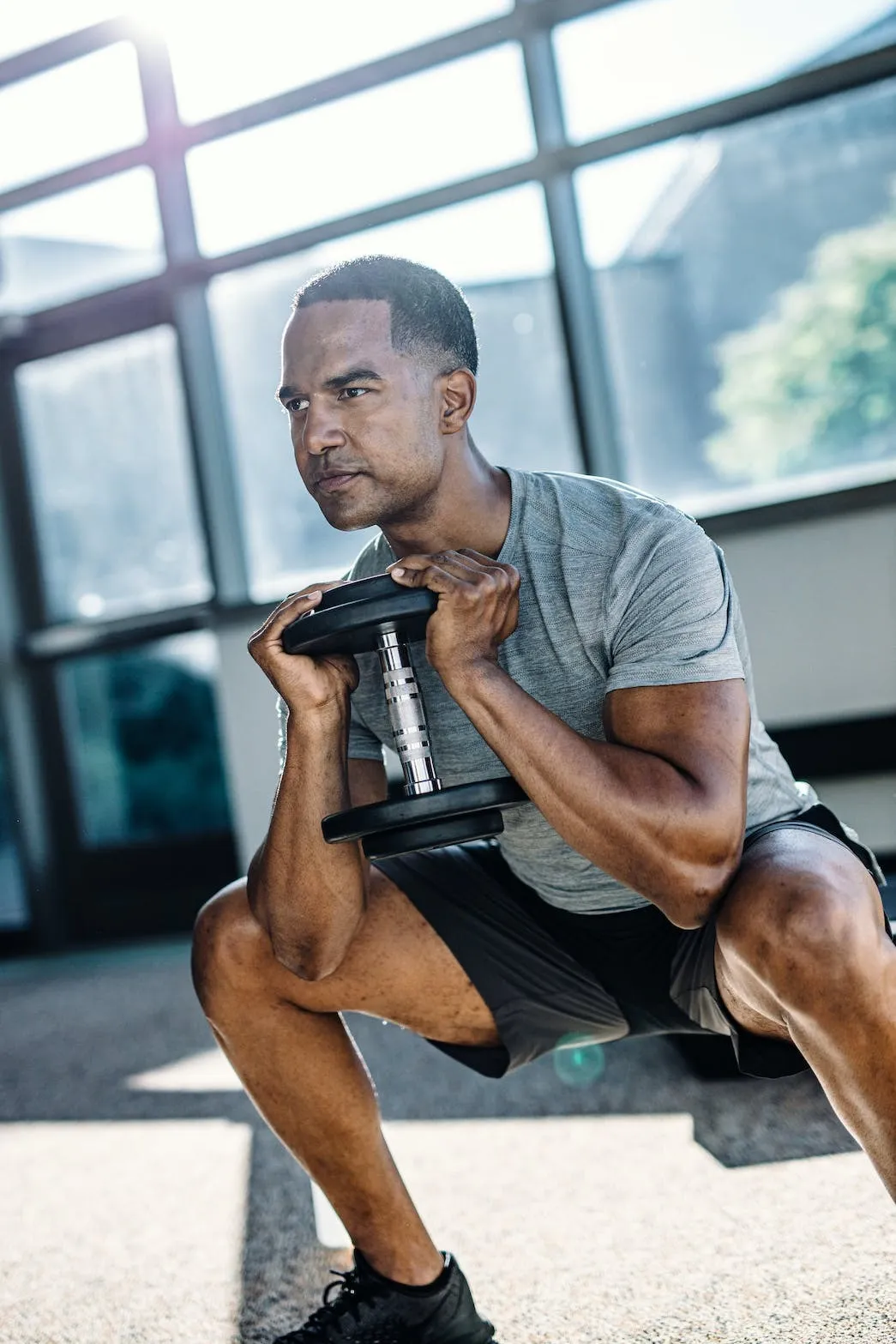 Image of man doing squats at the gym